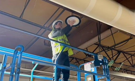 man working on lighting at height